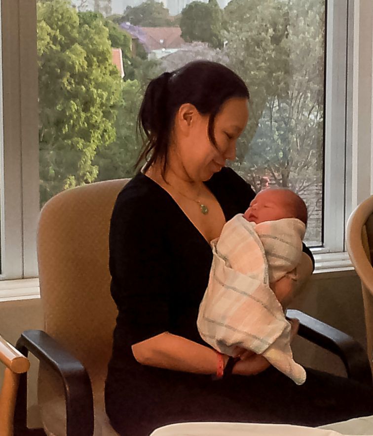 Dr Helen Fung holding her newborn daughter